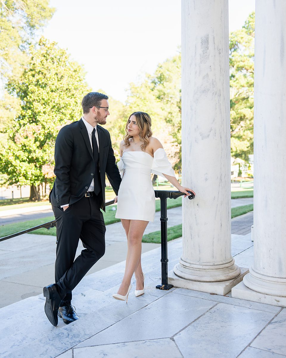 Engaged couple beside a column at the Brooks Museum of Art, Memphis