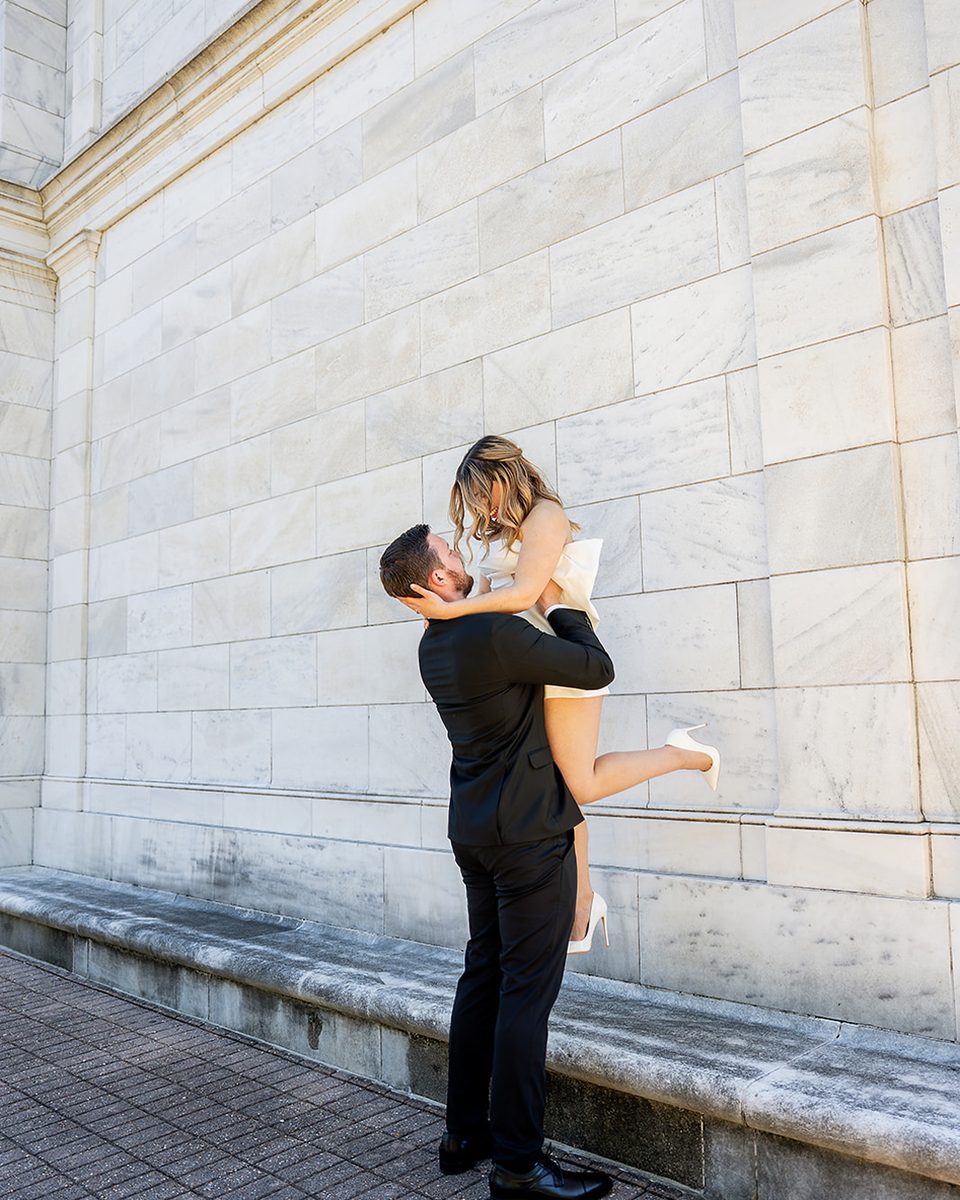 Groom lifting his fiancee at the Brooks Museum of Art, Memphis