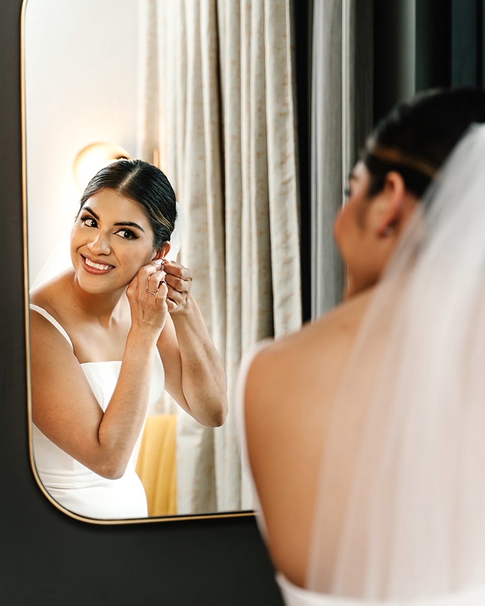 Bride getting ready in the mirror at a Hyatt Centric Memphis wedding