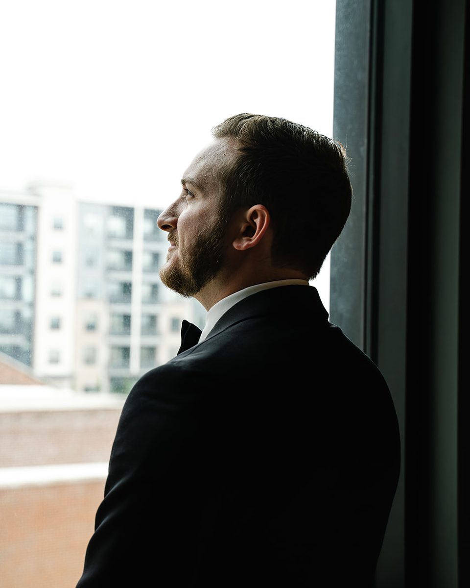 Groom portrait in window light at a Hyatt Centric Memphis wedding