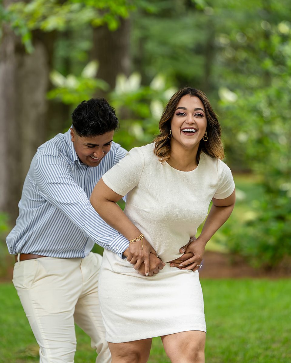 Engaged couple laughing together at Memphis Botanic Garden