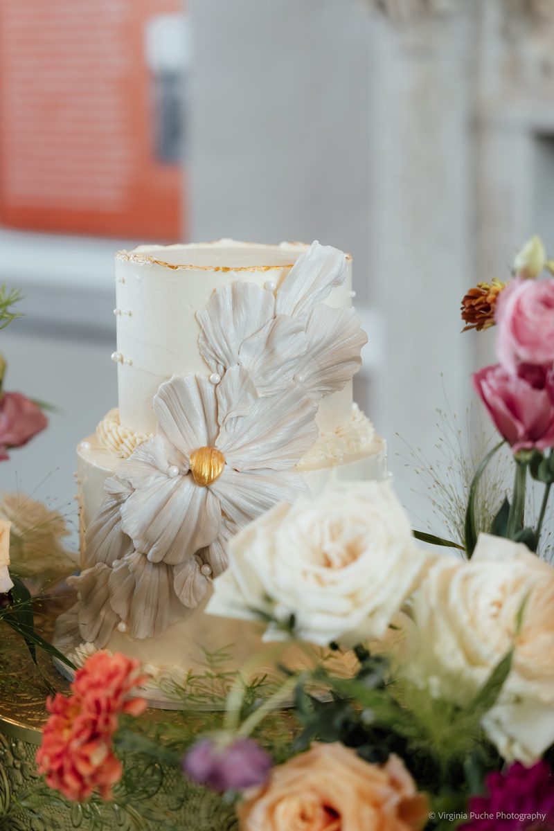 Memphis wedding cake surrounded by fresh florals
