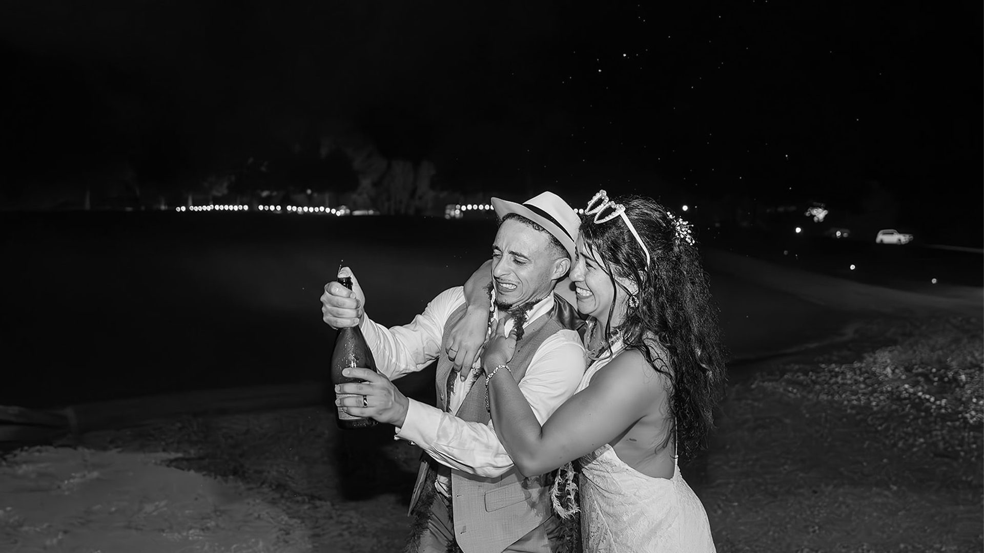 Memphis wedding couple celebrating with champagne at night in black and white
