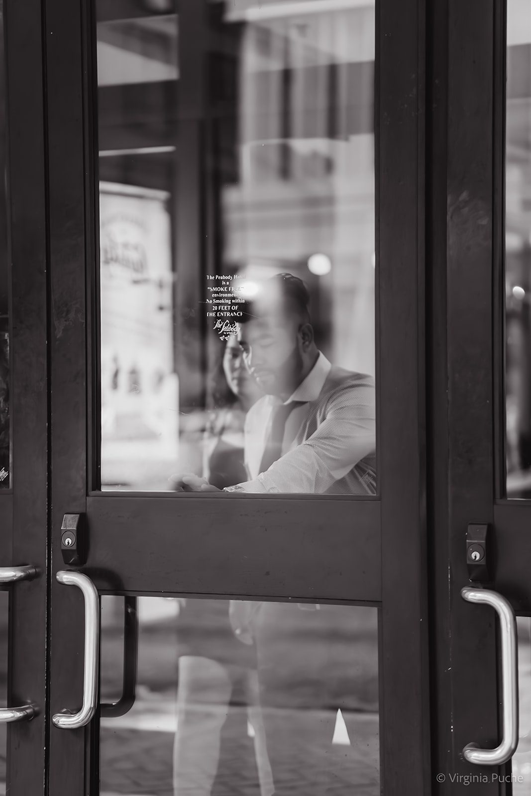 Memphis wedding couple reflected in glass doors in black and white