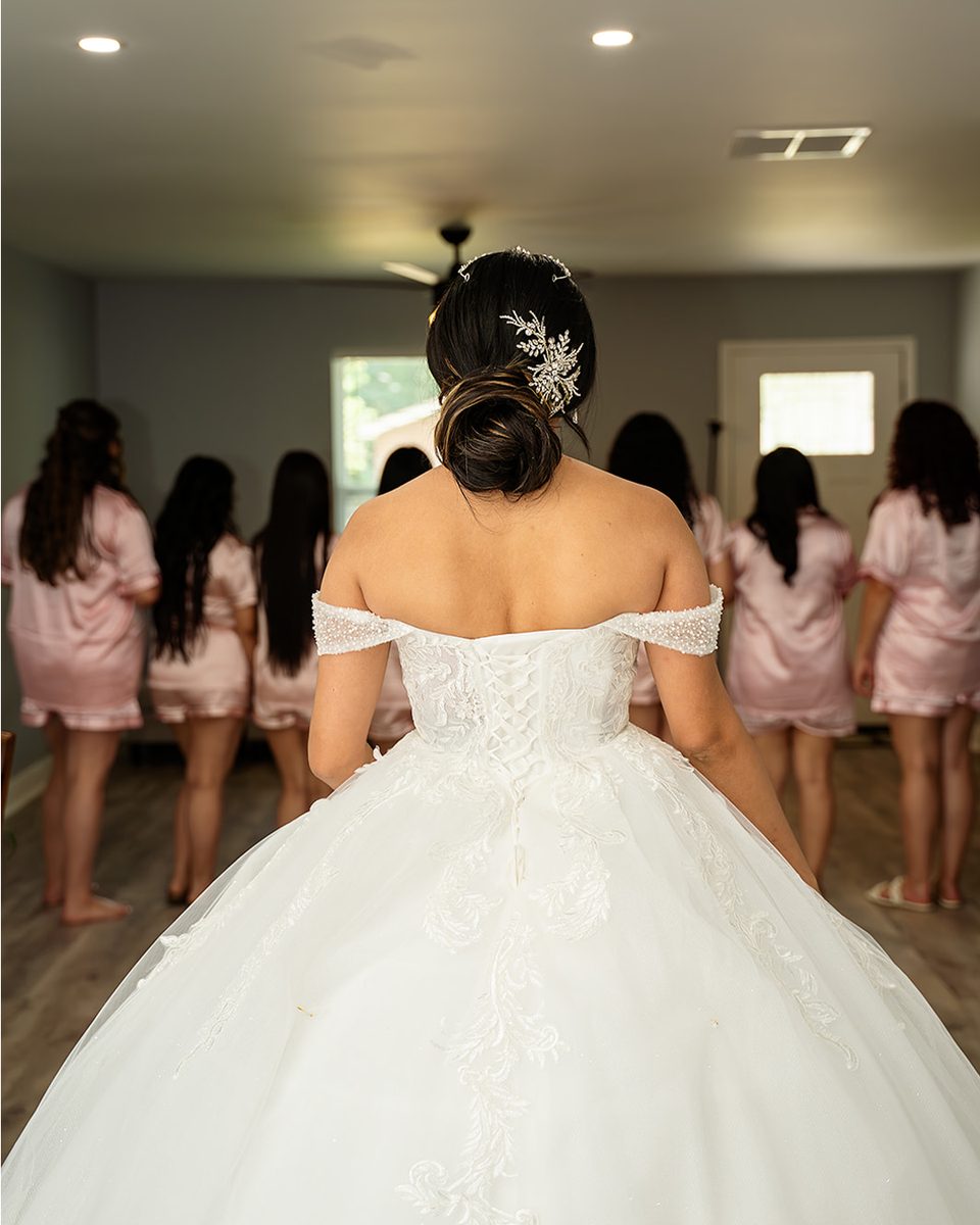 Bride revealing her gown to her bridesmaids at a Midtown Memphis wedding