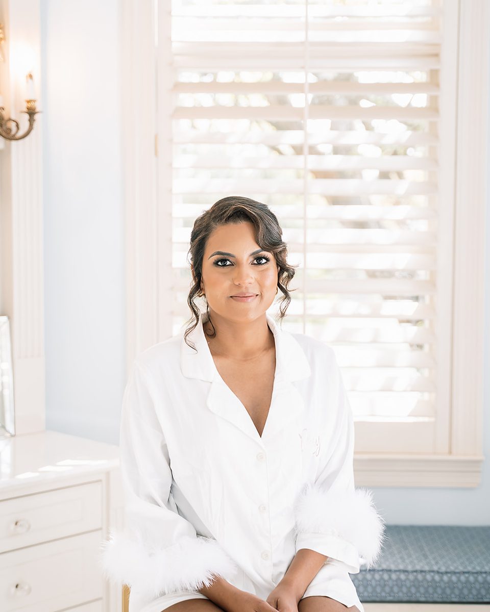 Bride in her robe by the window at an Orion Hill wedding