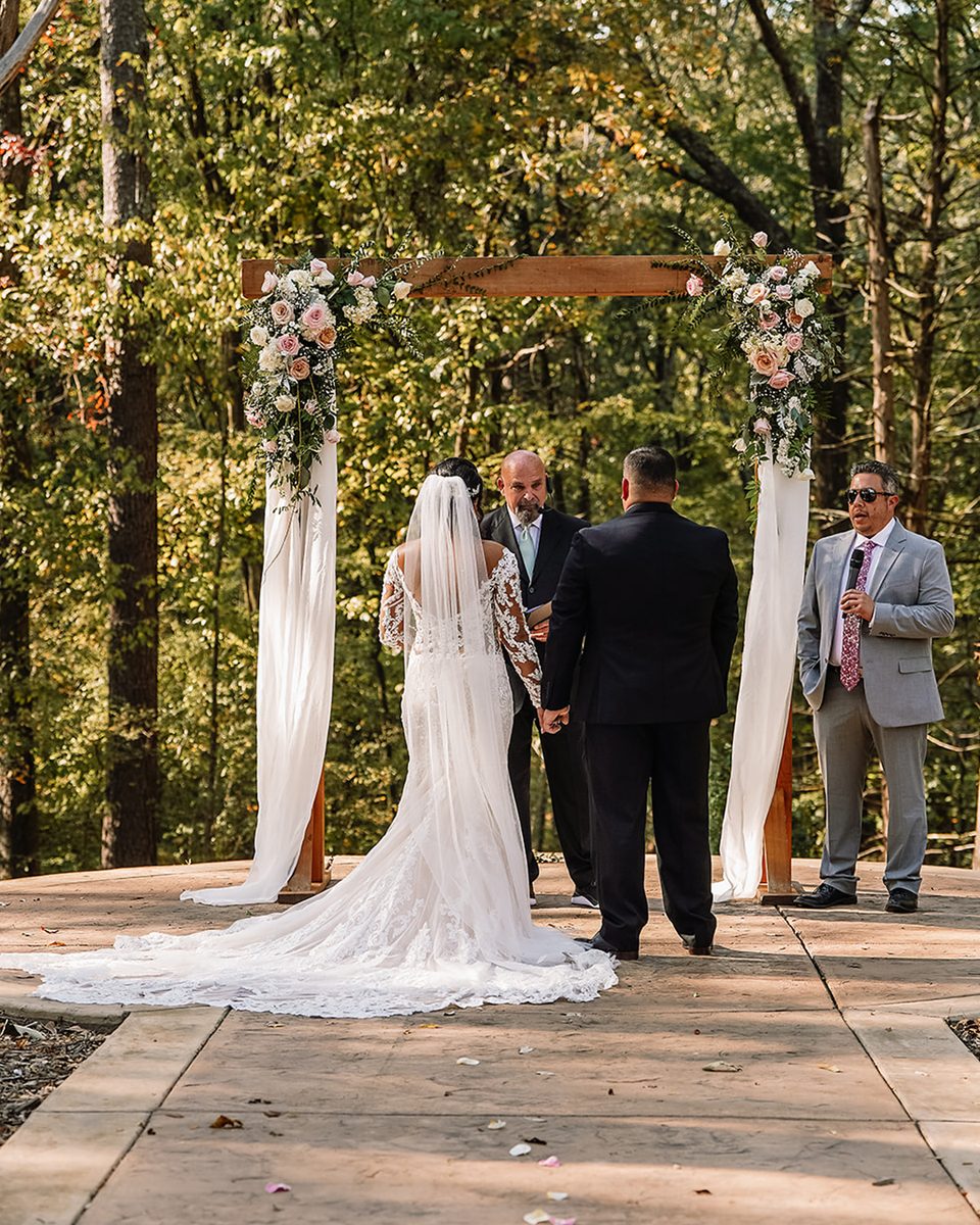 Bride walking a draped aisle at an Orion Hill wedding
