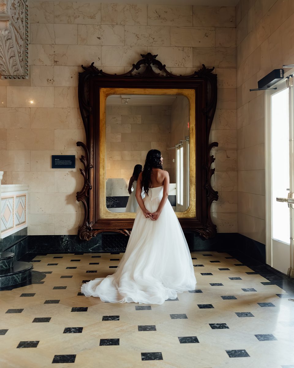 Elopement bride reflected in an ornate mirror at the Pink Palace Mansion, Memphis