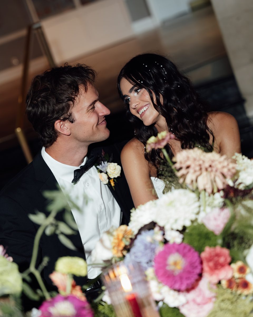 Elopement couple behind a table of florals at the Pink Palace Mansion, Memphis