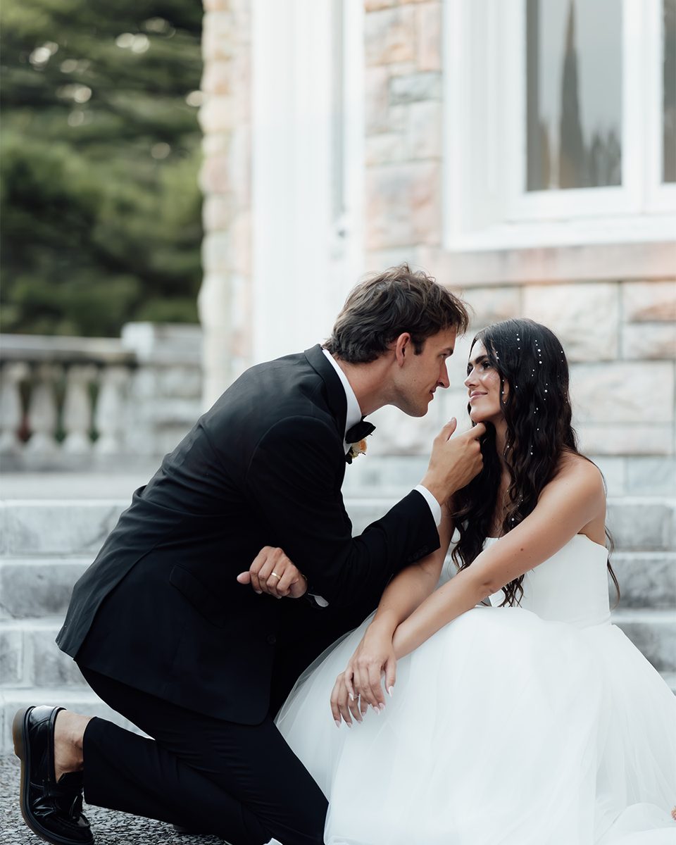 Groom kneeling to kiss the bride&rsquo;s hand at the Pink Palace Mansion, Memphis