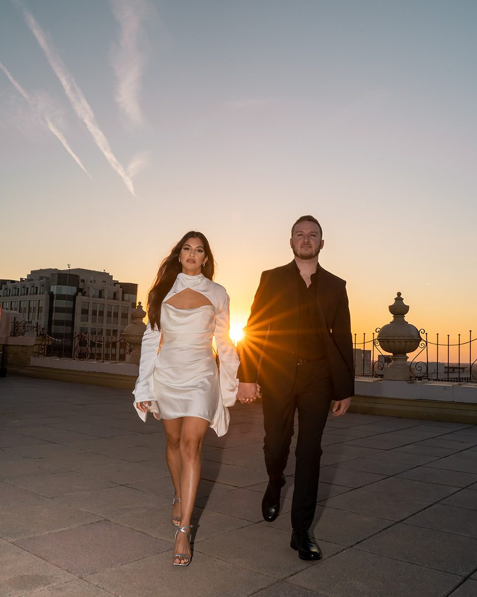 Engaged couple walking the Peabody Hotel rooftop at sunset, Memphis