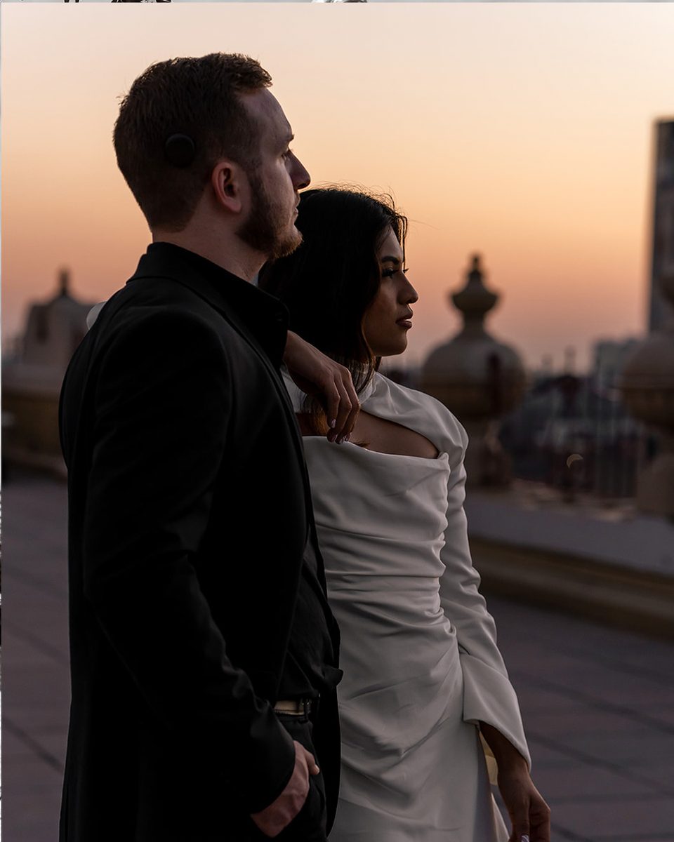 Engaged couple in profile at sunset on the Peabody Hotel rooftop, Memphis