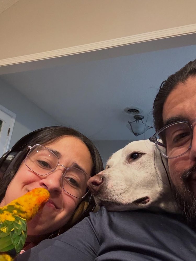 Virginia Puche with her husband, their dog and their sun conure